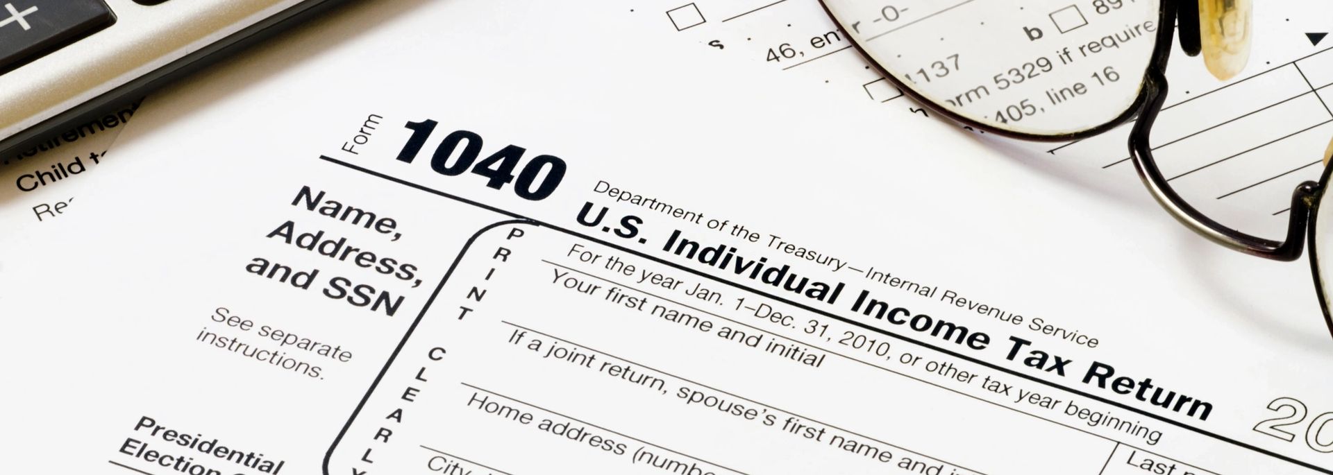 Corporate accounting desk with financial reports and calculators